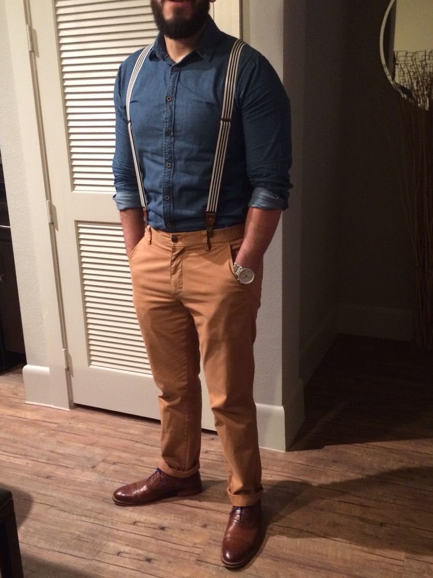 Man wearing a blue shirt, brown pants, and brown leather dress shoes.
