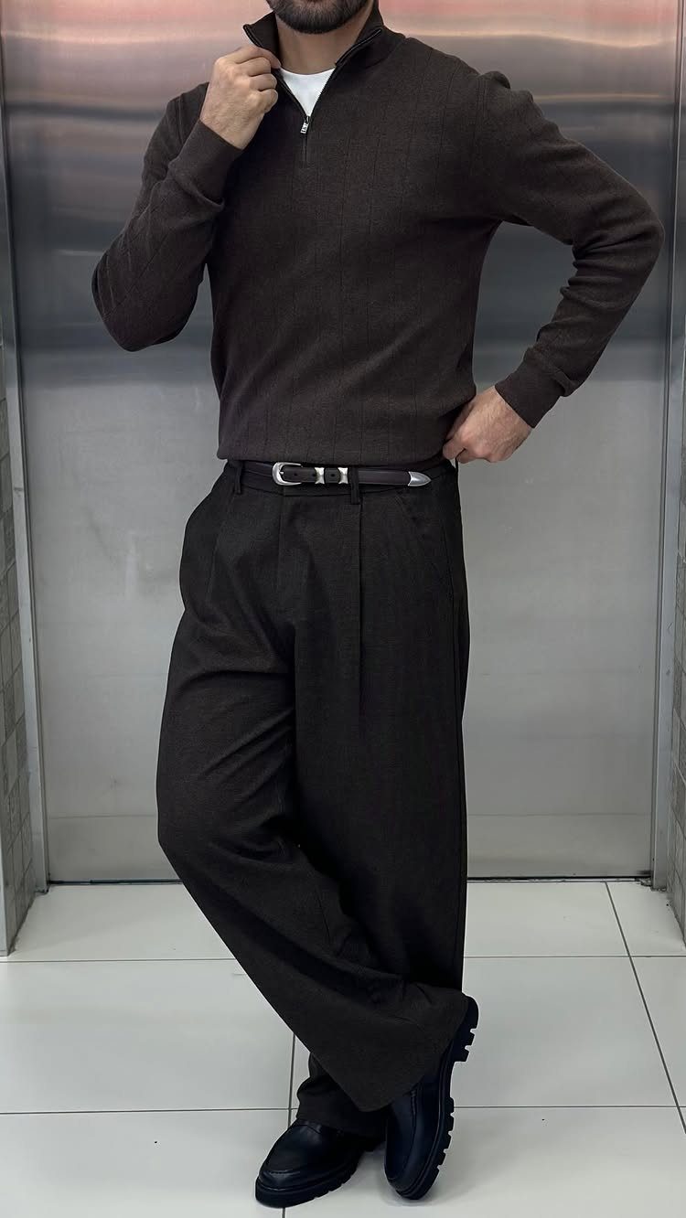 Man wearing a dark brown quarter-zip sweater and matching brown pleated chinos.