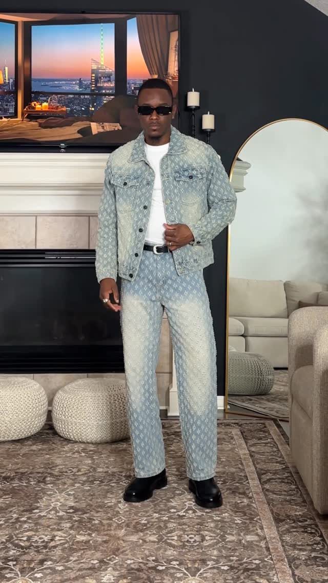 Man wearing a matching light-blue patterned denim jacket and jeans in a living room