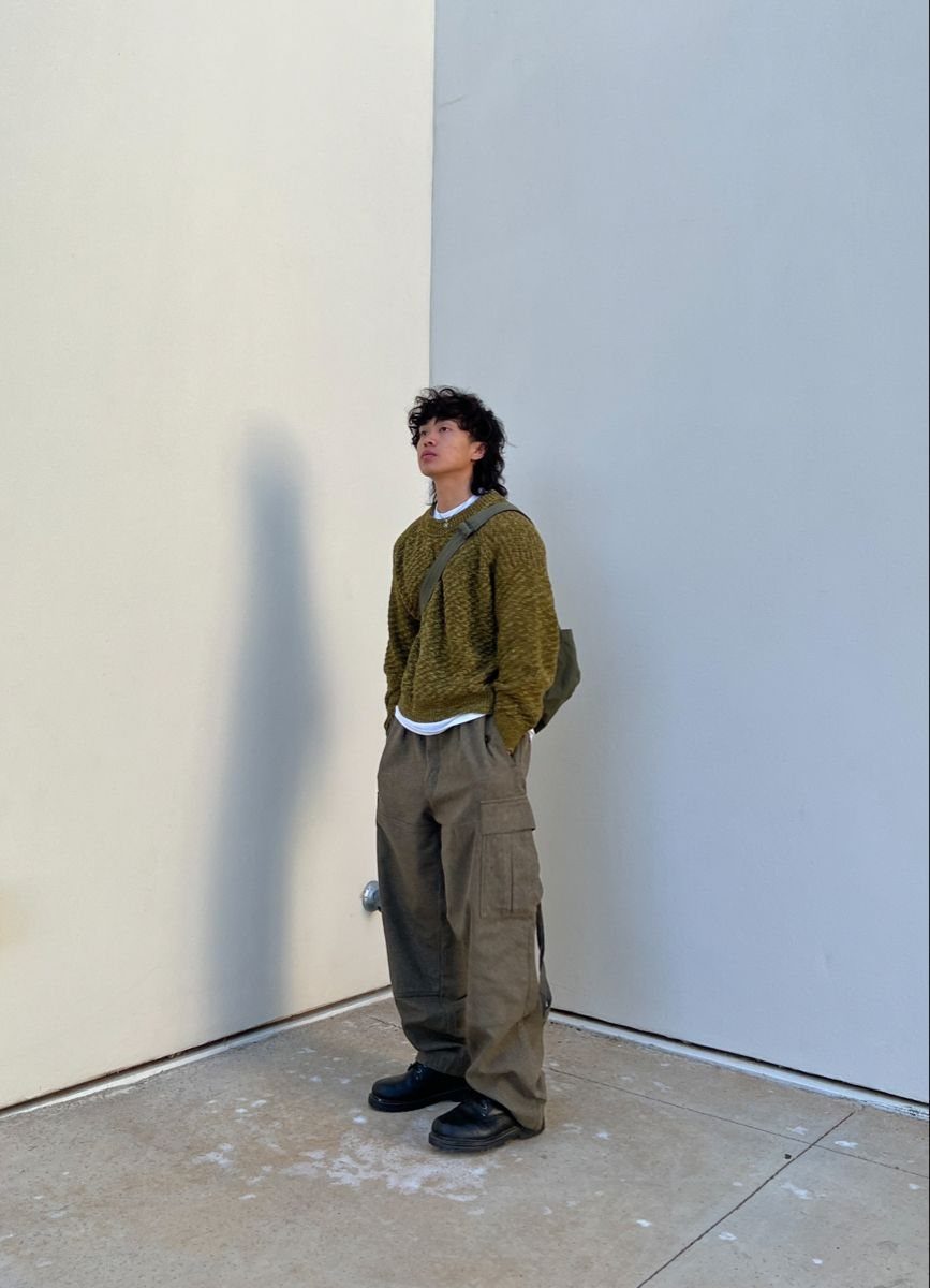 Man wearing an olive green cropped ribbed sweater and matching cargo pants.
