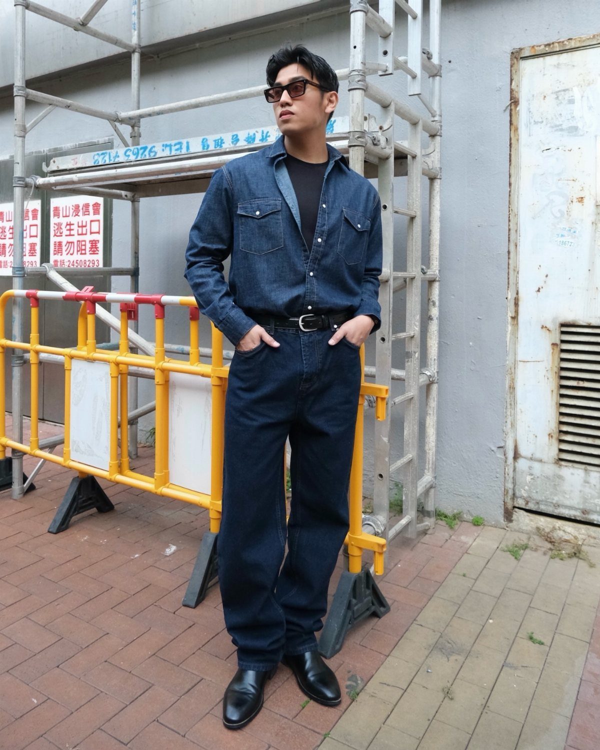 Man wearing a dark denim shirt, denim jeans, and black leather dress shoes.