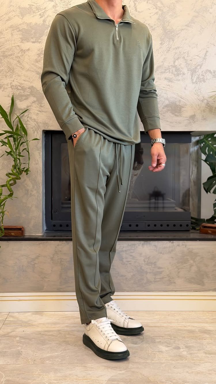 Man wearing olive green matching polo shirt and joggers with white leather sneakers.
