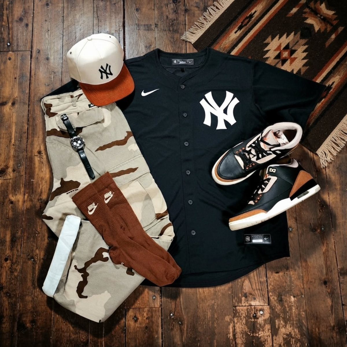 New York Yankees jersey and cap paired with camouflage pants and sneakers.
