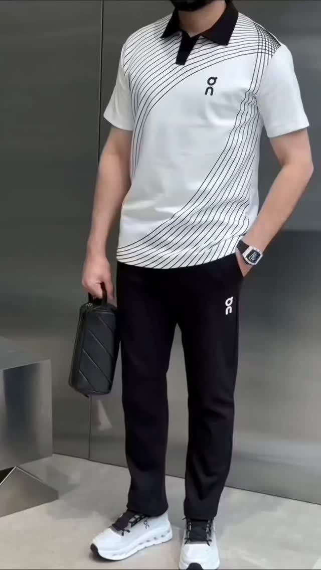 Man in a white striped polo, black athletic pants, and white sneakers.