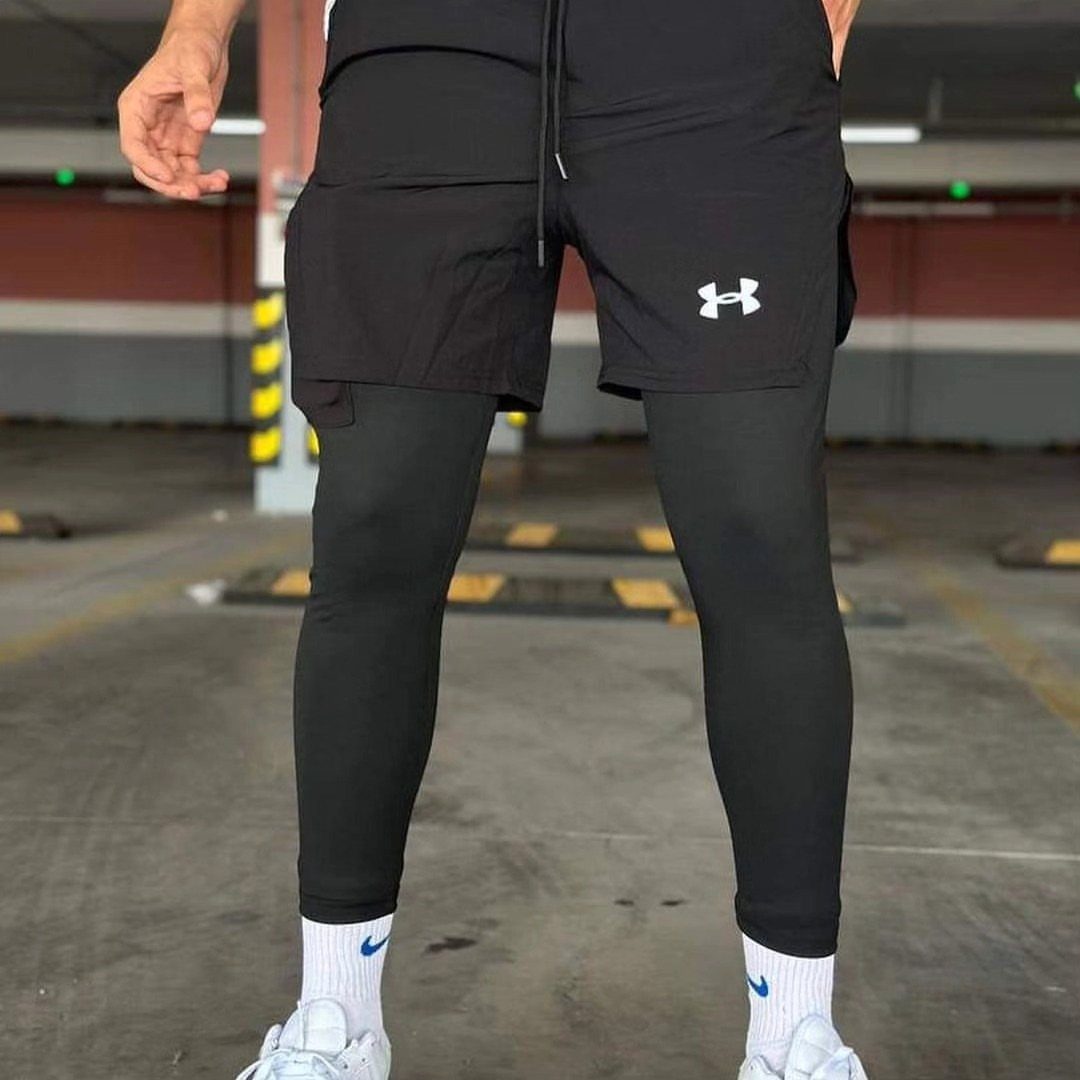 Person wearing black athletic shorts, black leggings, white socks, and white sneakers.