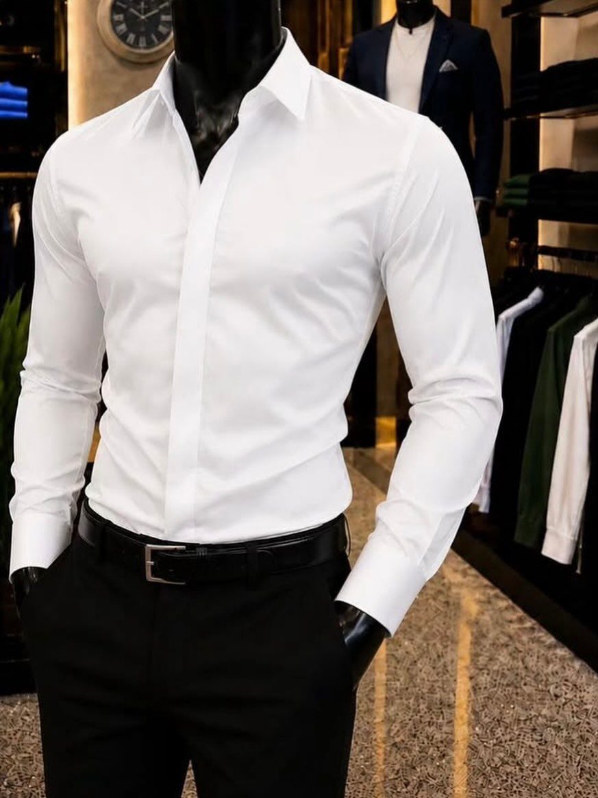 Slim fit white button down shirt on a mannequin with black trousers.